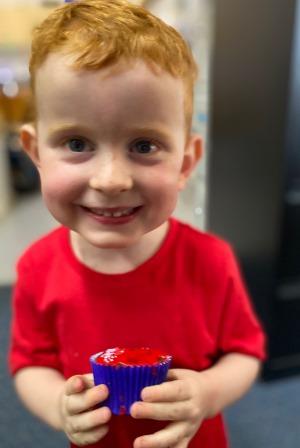 Lincoln holding a red cupcake