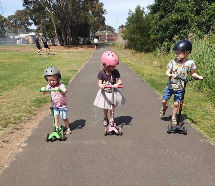Freddie and his siblings on scooters