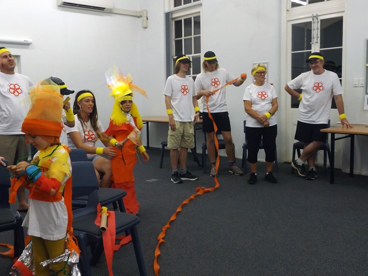 a camp group of adults and children dressing up for a game
