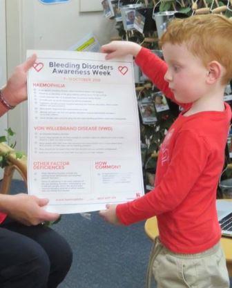 Lincoln presenting the Bleeding Disorders Awareness Week poster