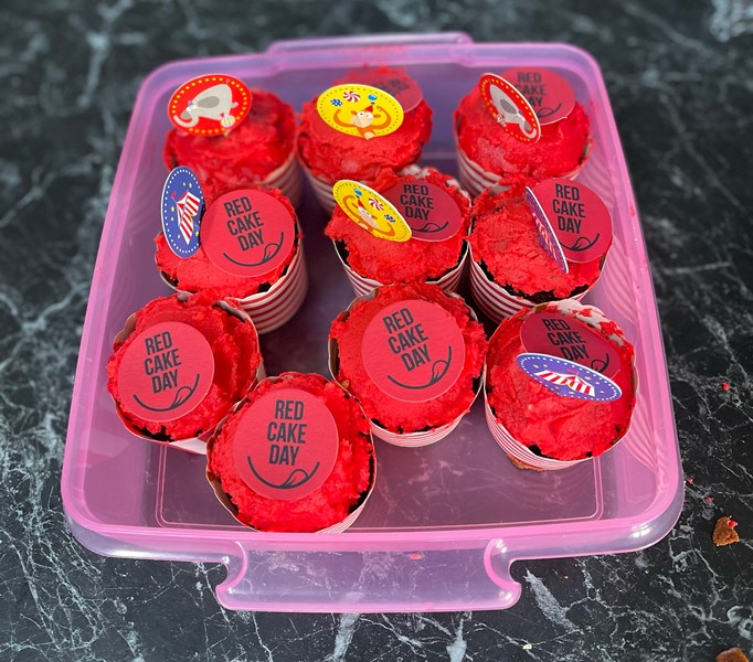 red cake day cupcakes in a container