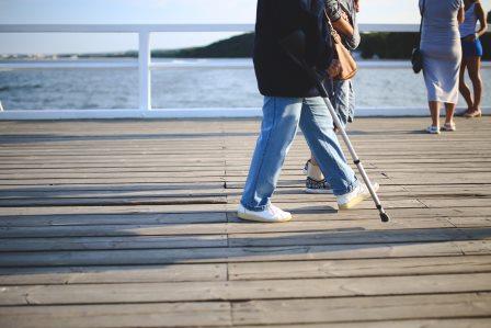 walking on pier with a stick