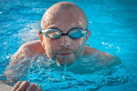 man in goggles swimming
