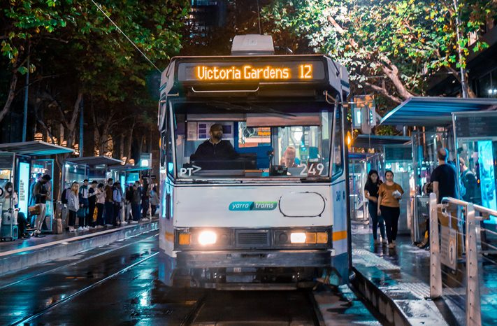 Melbourne tram - Photo by Pat Whelen: https://www.pexels.com/photo/people-walking-on-sidewalk-during-night-time-5614612/