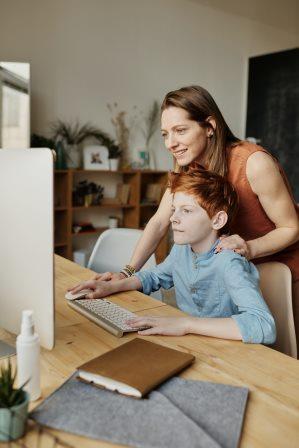 mother and son looking at imac - Photo by Julia M Cameron from Pexels