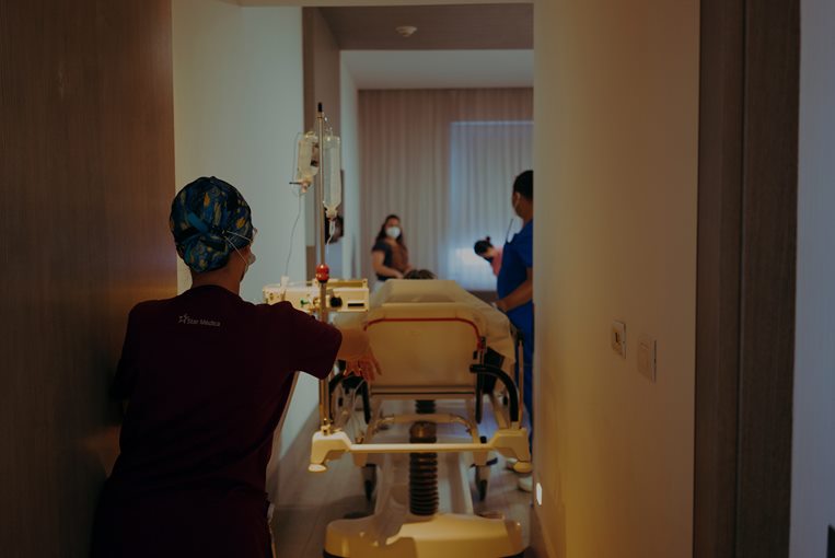 nurses wheeling hospital bed - isaac hermar for pexels.com