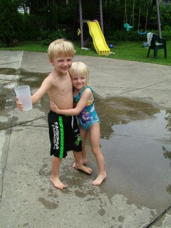 Siblings playing in water