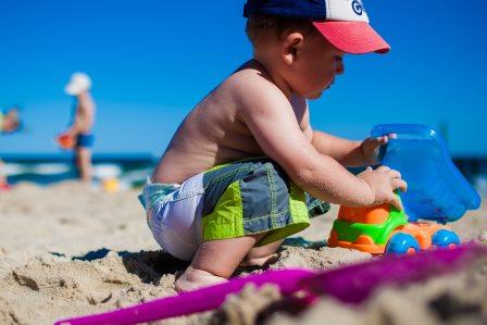 toddler playing on beach