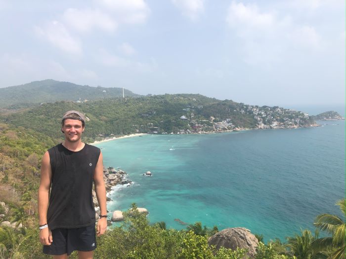 Young man standing on a bluff on Koh Tau island