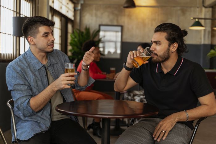 men drinking beer in a bar - Photo by Ketut Subiyanto: https://www.pexels.com/photo/men-drinking-beer-while-having-conversation-5054689/